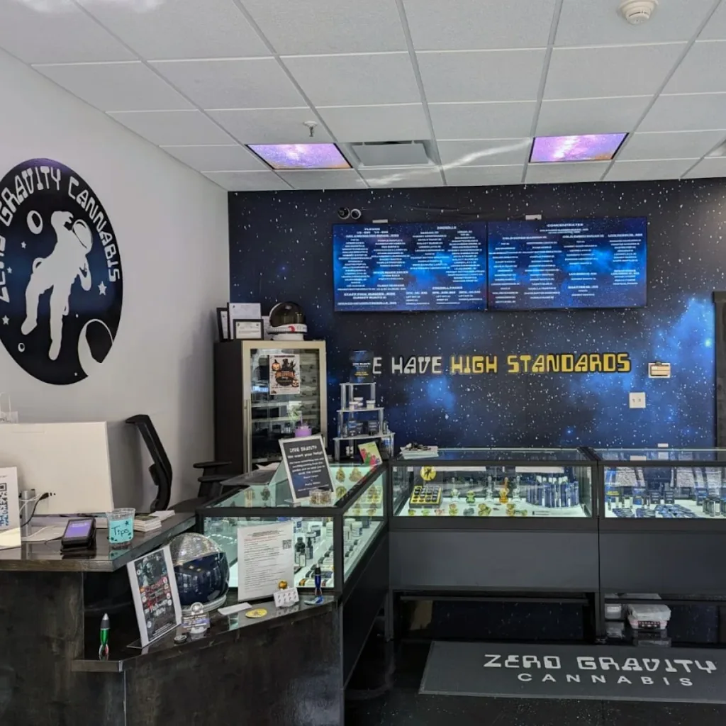 Zero Gravity Cannabis retail interior in Saco — service counter, galaxy mural, and We Have High Standards wall